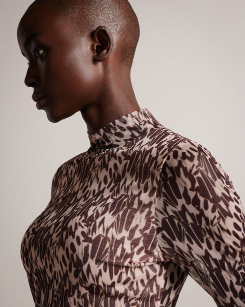 JUMILA-Tops-JUMILA is the ultimate in feminine style. Figure hugging fabric and our exclusive Wings print come together in this dainty top, which features a high neckline, long sleeves, and stretch fabric. This wardrobe staple can be can be worn with anything from tailored trousers to floaty skirts.The fabric of this product is made with 96% recycled polyester. Using recycled polyester helps divert plastic waste from ending in landfills and helps us to reduce our dependency on virgin materials. Fitted mesh